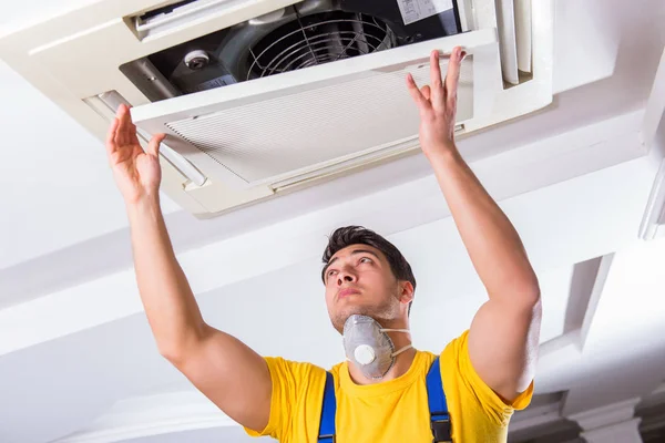 depositphotos_199933014-stock-photo-repairman-repairing-ceiling-air-conditioning